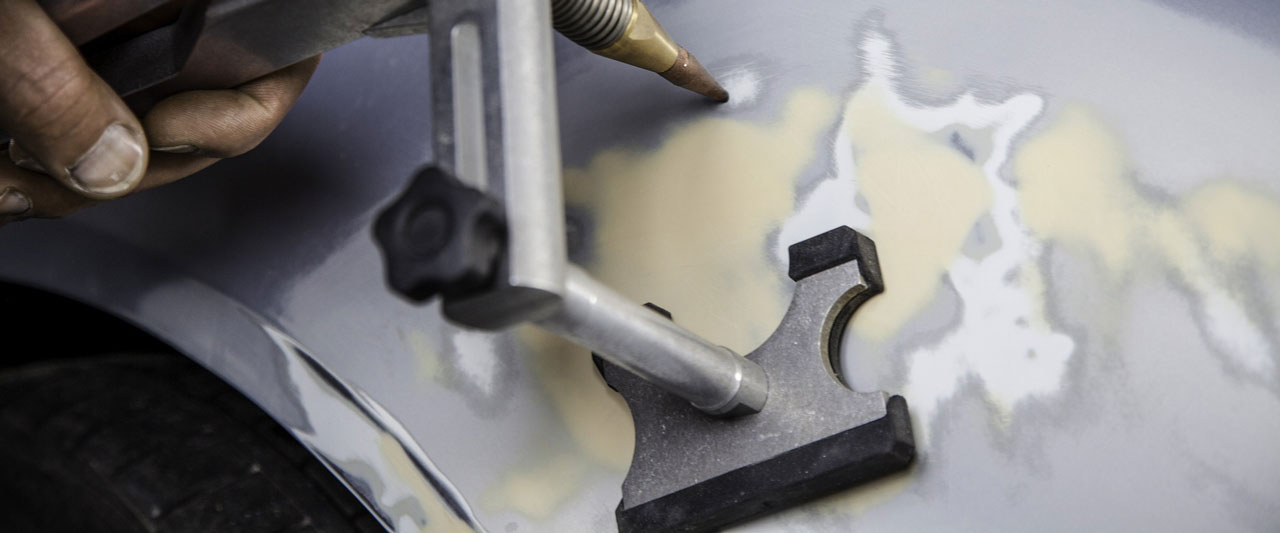 Bild zeigt Reparatur an einer Fahrzeugkarosserie. Das Bild dient zur Verdeutlichung der Services einer Karosseriewerkstatt